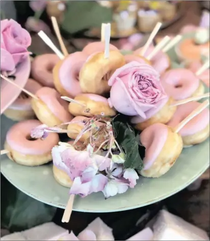  ??  ?? PERFECT POPS Putting wooden lolly sticks into doughnuts makes them easy to eat.PICTURES: GENEVIEVE FARRY