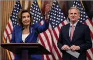  ?? ANDREW HARNIK — THE ASSOCIATED PRESS ?? House Speaker Nancy Pelosi of Calif. accompanie­d by House Minority Leader Kevin McCarthy of Calif., right, speaks before signing the CARES Act on Friday.