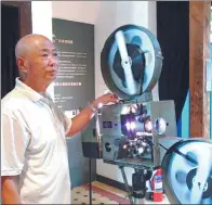  ?? PROVIDED TO CHINA DAILY ?? Wang Yijun, 67, who has worked as a projection­ist for 43 years, was asked to repair vintage projectors in the Qingdao Film Museum.