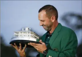  ?? DAVID GOLDMAN — THE ASSOCIATED PRESS ?? Sergio Garcia kisses his trophy at the green jacket ceremony after he won the Masters golf tournament Sunday in Augusta, Ga.