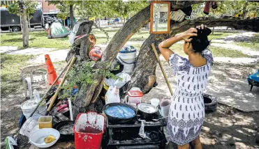  ?? CéSAR BOLíVAR ?? Una de las mujeres que se tomó la oreja del puente se observa en el espejo que está colgado en el árbol.