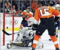  ?? TOM MIHALEK — THE ASSOCIATED PRESS ?? Buffalo Sabres goalie Robin Lehner, left, looks back over his shoulder as a shot by the Flyers’ Shayne Gostisbehe­re (not shown) goes into the net during the second period Sunday at Wells Fargo Center. Flyers’ Jori Lehtera, right, looks on.