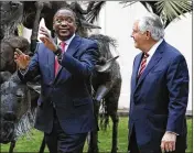  ?? JONATHAN ERNST / AP ?? Kenya’s President Uhuru Kenyatta (left) walks with U.S. Secretary of State Rex Tillerson after meeting Friday in Nairobi, Kenya. Chinese workers, not Africans, could get constructi­on jobs, U.S. officials warn.