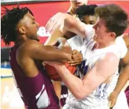  ?? STAFF PHOTO BY MATT HAMILTON ?? Colliervil­le’s Jordan Coleman, left, and Cleveland’s Grant Hurst battle for the basketball on Thursday in Murfreesbo­ro.