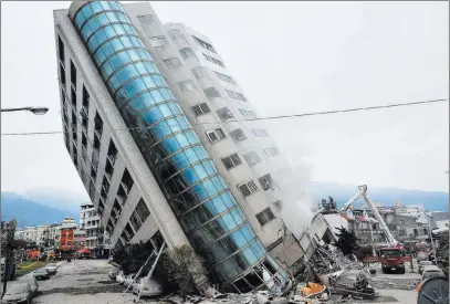  ??  ?? The Associated Press A residentia­l building leans on a collapsed first floor after an earthquake Wednesday in Hualien, southern Taiwan.