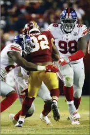  ?? PATRICK SEMANSKY - THE ASSOCIATED PRESS ?? New York Giants defensive tackle Damon Harrison (98) and strong safety Landon Collins (21) stop Washington Redskins running back Samaje Perine (32) during the second half of an NFL football game in Landover, Md., Thursday, Nov. 23, 2017.