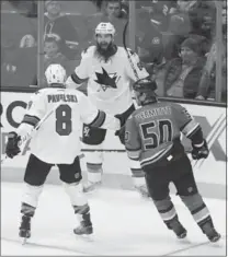  ?? LOS ANGELES TIMES FILE PHOTO ?? Brent Burns is congratula­ted by teammate Joe Pavelski after scoring the game-winning goal against the Anaheim Ducks on Dec. 27