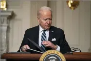  ?? EVAN VUCCI — THE ASSOCIATED PRESS FILE ?? President Joe Biden signs a series of executive orders on climate change Jan. 27 in the State Dining Room of the White House in Washington.