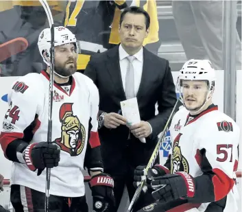  ?? GENE J. PUSKAR/AP ?? Ottawa head coach Guy Boucher, centre, stands behind Viktor Stalberg, left, and Tommy Wingels during the third period of a 7-0 Game 5 loss to the Pittsburgh Penguins on Sunday.