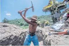  ?? PHOTOS BY AFP ?? A gravedigge­r before a funeral at the San Miguel Xico cementery on Wednesday, amid the coronaviru­s pandemic.