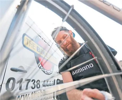  ??  ?? CYCLISTS were given a helping hand when an expert carried out free maintenanc­e work on their bikes.
Mike Wood (above), of the Bike Station, was in the city centre fixing and servicing bikes free of charge.
The service is funded by Dundee City Council...