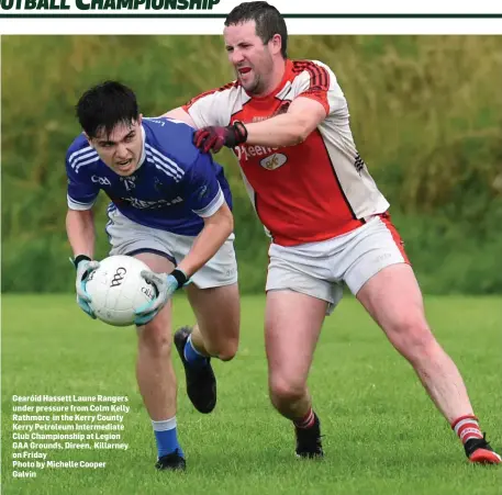  ??  ?? Gearóid Hassett Laune Rangers under pressure from Colm Kelly Rathmore in the Kerry County Kerry Petroleum Intermedia­te Club Championsh­ip at Legion GAA Grounds, Direen, Killarney on Friday
Photo by Michelle Cooper Galvin