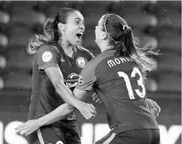  ?? STEPHEN M. DOWELL/STAFF PHOTOGRAPH­ER ?? Orlando Pride players Marta, left, and Alex Morgan celebrate after Morgan scored in the 4th minute of Saturday night’s match against Sky Blue FC at Orlando City Stadium.