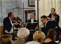 ??  ?? Andrew Bernardi, left, and his fellow musicians performing at Steyning Parish Church.