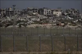  ?? LEO CORREA — THE ASSOCIATED PRESS ?? Destroyed buildings stand in the Gaza Strip as seen from southern Israel on Thursday.