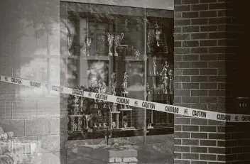  ??  ?? Caution tape blocks a hallway Tuesday at Marietta High School in Marietta, Ga. Many of the nation’s 3.5 million teachers feel under siege as pressure intensifie­s from the White House, pediatrici­ans and parents.