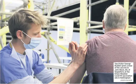  ?? JOSEPH RAYNOR ?? Vaccinator George Budden gives a dose of the vaccine to John Black, 65, of Stapleford, at the King’s Meadow Covid-19 vaccinatio­n site in Nottingham