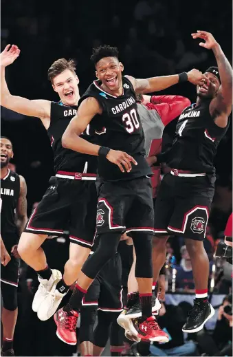  ?? JULIO CORTEZ/THE ASSOCIATED PRESS ?? South Carolina players celebrate after beating Baylor 70-50 in an East Regional semifinal game of the NCAA men’s college basketball tournament Friday in New York.