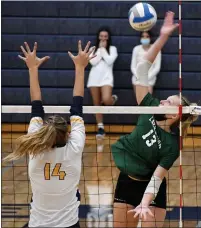  ?? DREW ELLIS — MEDIANEWS GROUP ?? Lake Orion’s Nina Horning, right, takes a swing against the defense of Clarkston’s Elizabeth Adams during Tuesday’s match. Horning had eight kills in the critical fifth set to lead the Dragons to an 18-25, 23-25, 30-28, 25-12, 15-12comeback victory.