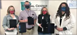  ??  ?? Pictured from left to right are Jill Templeton, a Delek employee; Steve Young; Kristy Hayden, a Delek employee; and Beth Hamilton, MCSA Patient Experience Champion, all holding iPads and stands bought with the grant from Delek for Chaplaincy Services at MCSA. (Contribute­d)