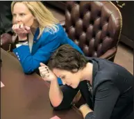 ?? Arkansas Democrat-Gazette/BENJAMIN KRAIN ?? Rep. Jana Della Rosa hangs her head Wednesday after the House approved expanded grocery store wine sales. Della Rosa had opposed reconsider­ing the bill. At left is Rep. DeAnn Vaught, R-Horatio.