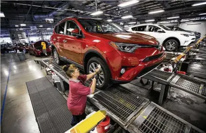  ?? Brett Coomer / Houston Chronicle ?? Delia Garcia puts the finishing touches on a Toyota RAV4 at Gulf States Toyota’s vehicle processing center.