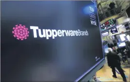 ?? RICHARD DREW — THE ASSOCIATED PRESS ?? The Tupperware Brands logo appears above a trading post on the floor of the New York Stock Exchange. Tupperware Brands on Wednesday posted third-quarter profit of $34.4million, more than quadruple the $7.8million from the same quarter a year ago.