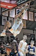  ??  ?? Valparaiso’s Markus Golder hangs onto the rim after dunking against Northern Iowa on Saturday.