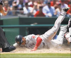  ?? Nick Wass / Associated Press ?? Rafael Devers slides home to score on a sacrifice fly by Jackie Bradley Jr. during the seventh inning on Wednesday.
