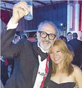  ??  ?? The author Cheryl Tiu with this year’s number one — Osteria Francescan­a’s Massimo Bottura after the World’s 50 Best Restaurant­s awarding ceremony.