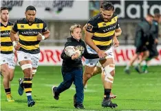  ??  ?? George Gadsby, 8, heads out with Angus Ta’avao at the start of the match.