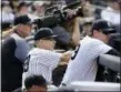  ?? THE ASSOCIATED PRESS ?? Yankees manager Joe Girardi, center, watches Tyler Clippard pitch in the ninth inning Saturday.