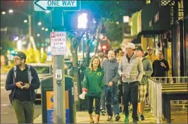  ?? Photograph­s by Irfan Khan Los Angeles Times ?? RESIDENTS frustrated by homeless camps patrol Belmont Shore early Friday. One woman said homeless people had gotten “too comfortabl­e” in the community.