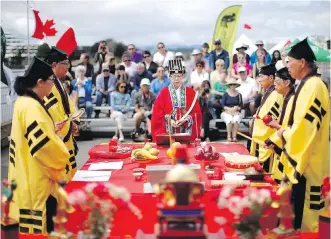  ??  ?? Four-year-old Miyu Loo gets help dotting the eyes from Lee Porter, left, and Jennifer Loo at the ceremonial launch of the 23rd annual Dragon Boat Festival at Ship Point on Friday. At right, Taoist priests and a high priestess awaken a mythologic­al...