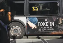  ?? Michael Short / Special to The Chronicle ?? A San Francisco bus displays an ad for the Urban Pharm marijuana dispensary. New rules set by Propositio­n 64 will restrict licensed marijuana sellers from placing billboards near interstate highways, schools and playground­s.