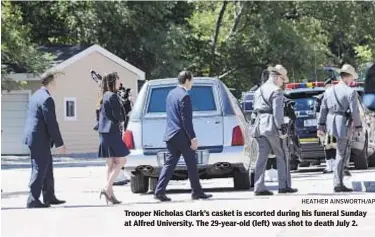  ?? HEATHER AINSWORTH/AP ?? Trooper Nicholas Clark’s casket is escorted during his funeral Sunday at Alfred University. The 29-year-old (left) was shot to death July 2.