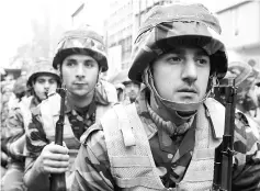  ??  ?? In this file photo shows members of Iran’s paramilita­ry Basij militia parade in front of the former US embassy in Tehran, to mark the national Basij week. — AFP photo