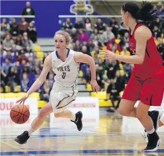  ?? CHAD HIPOLITO, THE CANADIAN PRESS ?? Vikes guard Jenna Krug looks for an opening against the Ravens during the first half of their quarterfin­al at CARSA gym on Thursday night.