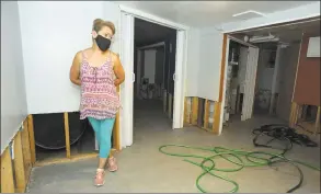  ?? Ned Gerard / Hearst Connecticu­t Media ?? Adriana Arista stands in the basement of her home in Bridgeport on July 17. Water damage is currently being repaired after the basement filled with a couple of feet of water during heavy storms in late June and early July.