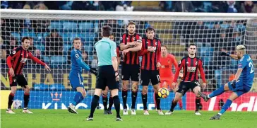  ??  ?? Inspired: Riyad Mahrez whips home a last-minute free-kick to rescue Leicester