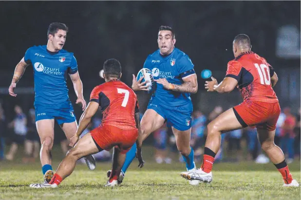  ?? Picture: CHRIS HOLMES ?? STRONG SHOWING: Italy's Paul Vaughan charges into the Tongan defence during the World Cup warm-up game in Innisfail on Friday night.