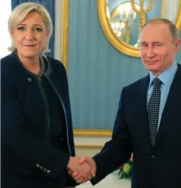  ??  ?? Shake on it: Vladimir Putin and Marine Le Pen yesterday