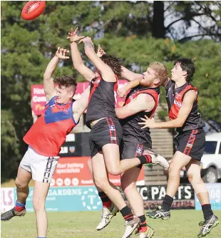  ??  ?? Nilma-Darnum players Hayden Potts and Jarrod Stewart spoil the marking attempt of their Buln Buln opponent; Photograph­s: Tom Elton.