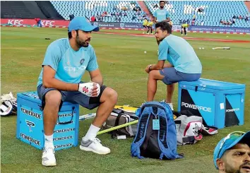  ??  ?? Rohit Sharma ( left) and Kuldeep Yadav take a break from training.