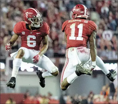  ?? AP/VASHA HUNT ?? Alabama wide receivers Henry Ruggs III (11) and DeVonta Smith celebrate after Ruggs’ touchdown reception during the top-ranked Crimson Tide’s victory over Auburn on Saturday at Bryant-Denny Stadium in Tuscaloosa, Ala.