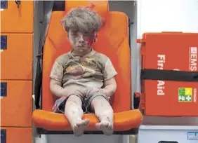  ?? ALEPPO MEDIA CENTER VIA AP ?? In this Aug. 17 photo, 5-year-old Omran Daqneesh sits in an ambulance after being pulled from a building hit by an airstrike in Aleppo.