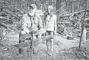  ??  ?? John Lithgow (left) and Jeté Laurence in a scene from 'Pet Sematary', a tale of a creepy burial ground deep in the woods near a family's new home. The new release, horror film stands at No. 2. — Paramount Pictures