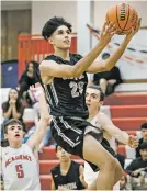  ?? CRAIG FRITZ/FOR THE NEW MEXICAN ?? Capital’s Seth Arroyos makes a layup while passing Albuquerqu­e Academy defenders Michael Martinez, left, and Chris Harvey on Wednesday in Albuquerqu­e.