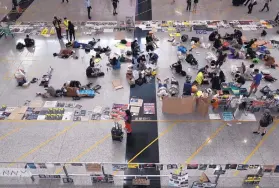  ?? VINCENT YU/ASSOCIATED PRESS ?? Flight operations resumed today at the airport in Hong Kong after two days of disruption­s. However, protesters continued their sit-in demonstrat­ions.