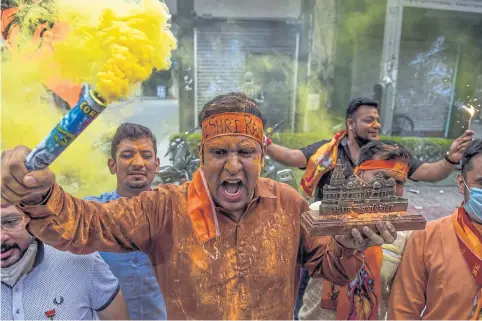  ?? AFP ?? Bharatiya Janata Party supporters shout slogans as they celebrate before the groundbrea­king ceremony of the Ram Temple in Ayodhya yesterday.